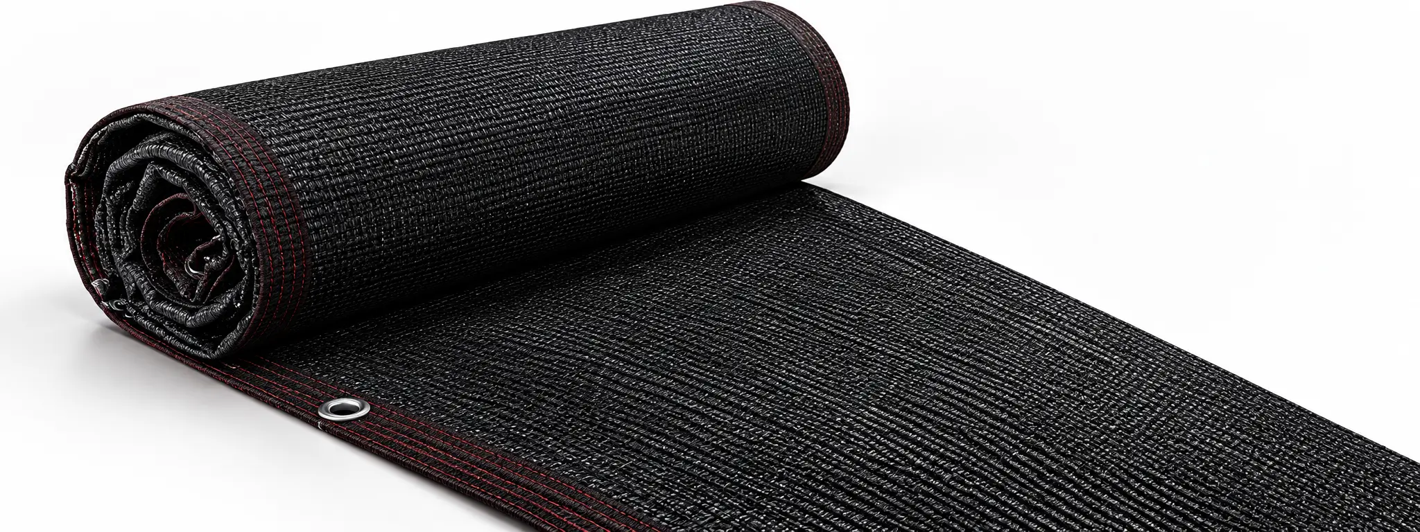 Close-up of black shade netting roll with reinforced edges and eyelets